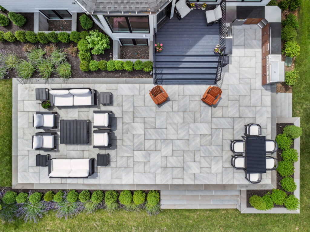 a bird's eye view of tiled outdoor patio with seating areas